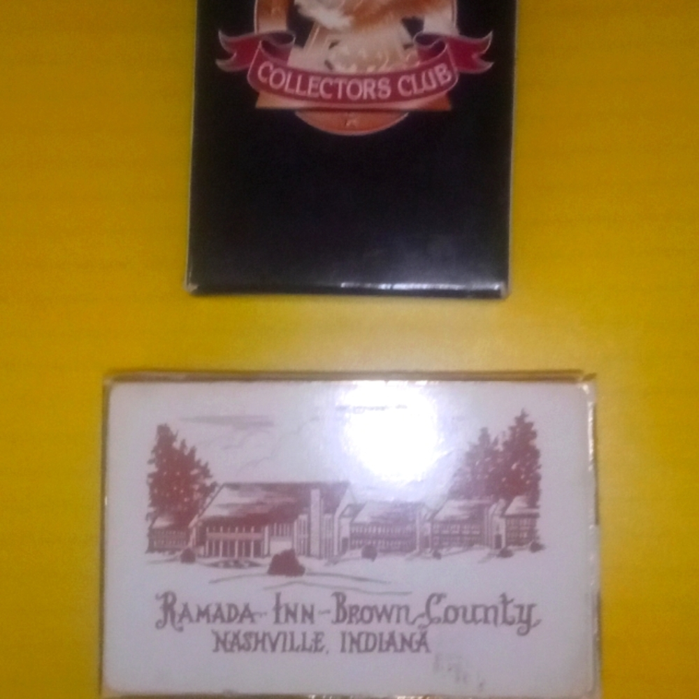 Two decks of vintage playing cards with logos.